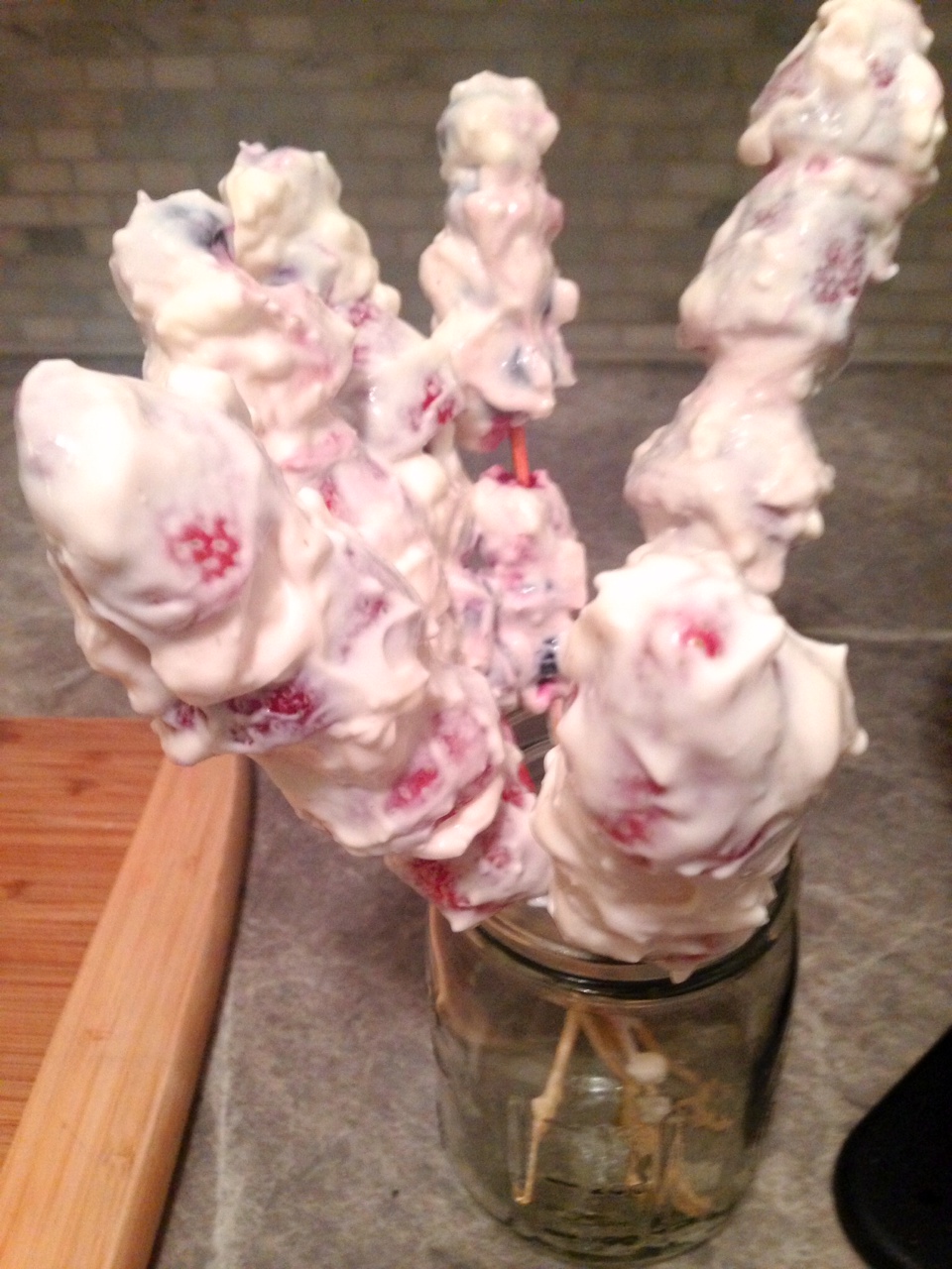 Image of fruit kabobs after being rolled in yogurt, then placed in a mason jar